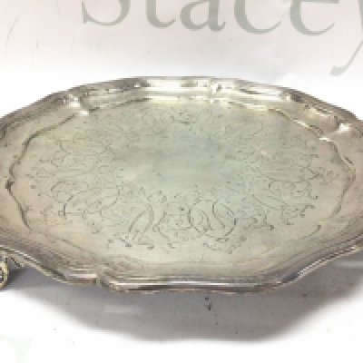 A three footed silver card tray , 22cm wide. Marked Birmingham 1858. Postage cat B
