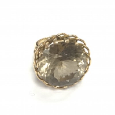 An unmarked gold ring set with large smoked quartz. Size N and 12.78g