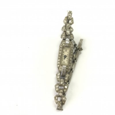 A platinum art deco cocktail watch. Winds and runs. Approximately 18.20g