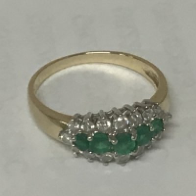 A 14carat gold ring set with emerald and small diamonds and emeralds. 2.5g approximately.