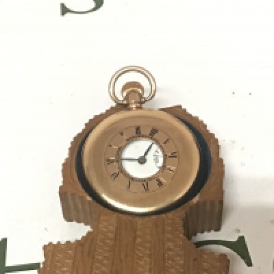 A gold plated half hunter pocket watch button wind seen working.in a carved wood Swiss watch case