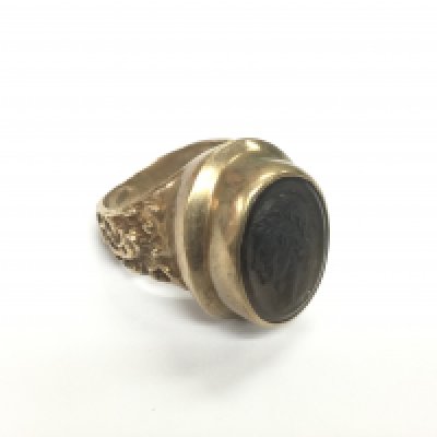 A 9ct gold ring set with an intaglio cut Romanesque figure in profile, approx 17.3g and approx size P. Shipping category A.