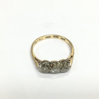 An 18ct gold ring set with three small diamonds, approx 2.3g and approx size N. Shipping category A.