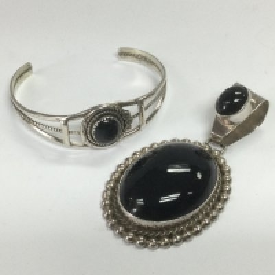 A large silver pendant set with black stones plus a silver bangle set with a central black stone (2). Shipping category A.