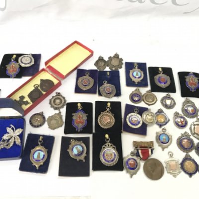 A large collection of pendant with the vast majority being silver.