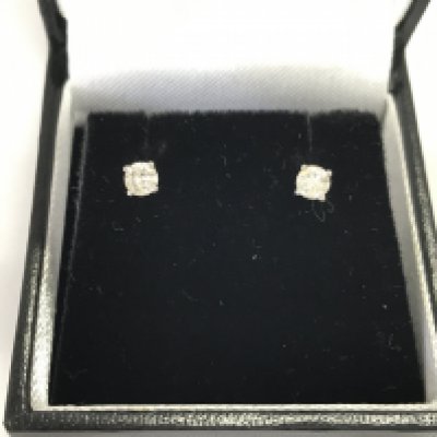 A pair of 9ct white gold diamond studs approximately 0.33ct. Postage A