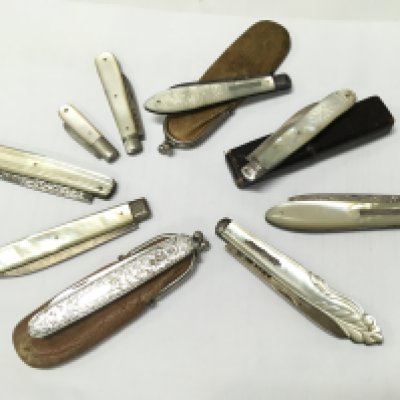 A collection of Mother of Pearl knives and silver hallmarked fruit knives . This lot cannot be posted
