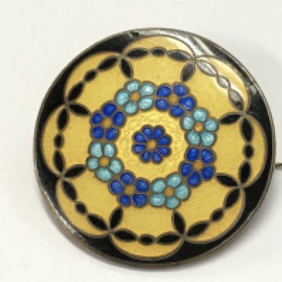An unmarked enamel brooch , postage category A