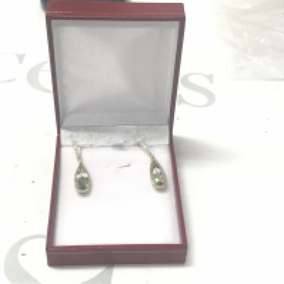 Pair of 9ct yellow gold long drop earrings set with pear shaped green amethysts surrounded by RBC diamonds, with further RBC diamonds to the bales and loops, boxed. Amethysts 6.62ct. Diamonds 0.45ct.