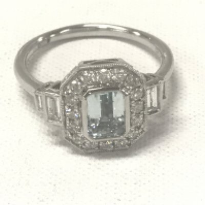Platinum Art Deco style ring set with a central emerald-cut aquamarine, with RBC and baguette cut diamonds. Aquamarine 0.75ct. Diamonds 0.57ct