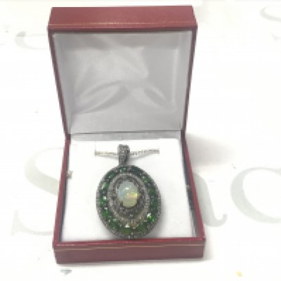Statement piece pendant set with an oval cabochon opal, chrome diopsides and diamonds in silver, on a silver chain, boxed. Opal 2.00ct approx. Diopsides 3.00ct approx. Diamonds 0.85ct approx.