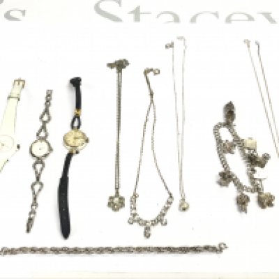 A collection of silver jewellery including a charm bracelet and some watches. Postage B
