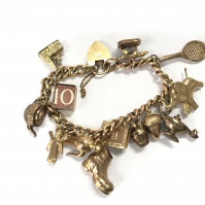 A 9ct gold charm with various 9ct charms. 39.44g