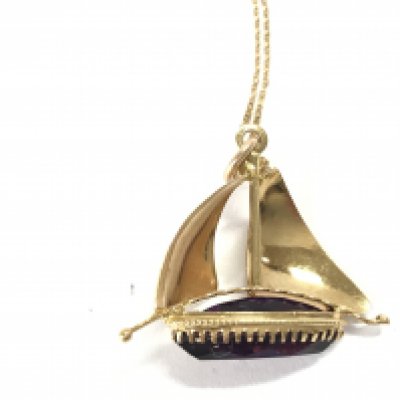 An 18ct gold pendant in a ship design set with an amethyst on chain. 7.70g Postage B