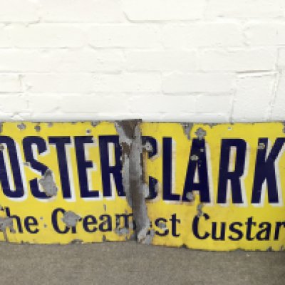 broken and weathered enamel advertising sign for Foster Clarks specifically "The Creamiest Custard. 56 x 21 inches approximately