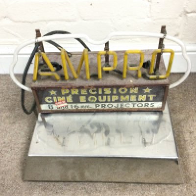 An AMPRO neon sign on chrome stand. Overall size is approximately 18 x 16 inches