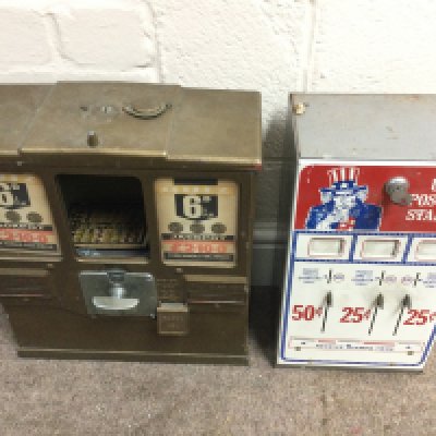 A US postage stamp coin op machine 8 x 14 x 5.5 inches approximately and a British &ldquo;6D&rdquo; &ldquo;Premiere Gum and Card Vendor&rdquo; trade stimulator 12 x 15 x 6 approximately