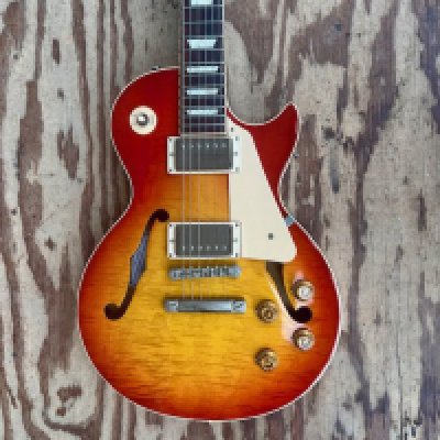 A 2015 Gibson ES Les Paul Hollow Light Burst electric guitar with flame maple top. 2 humbucker pickups - all original. These were only manufactured between 2014 -and 2015. The guitar comes with Original Brown Gibson Case and certificate in very good overall condition. Very light wear to back, light playwear overall. serial number 11465730