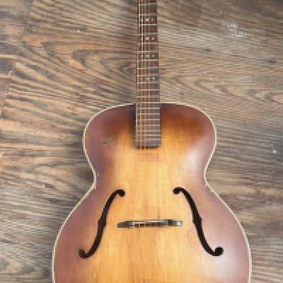 A late 1950's early 1960's Hofner 450 series acoustic guitar with changed tuners and no pickguard - average condition consistent with age and use.