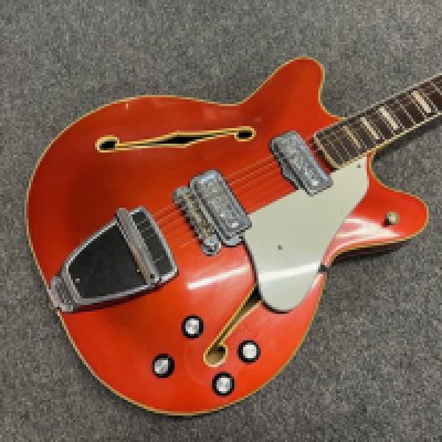 A 1967 Fender Coronado II 6 string electric guitar. Candy Apple Red metallic with matching headstock. Finish has aged with yellowing to clearcoat lacquer. All original parts. Extensive playwear. Some edgewear to back, sides and headstock. Significant playwear and tarnishing to frets and fingerboard. Comes with non original gig bag.