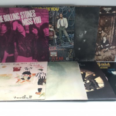 Two bags containing 15 rock LPs by various artists including The Rolling Stones, The Who, John Lennon and others plus a pink vinyl 12" Stones single.
