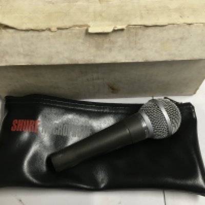 A boxed Shure SM58 microphone.