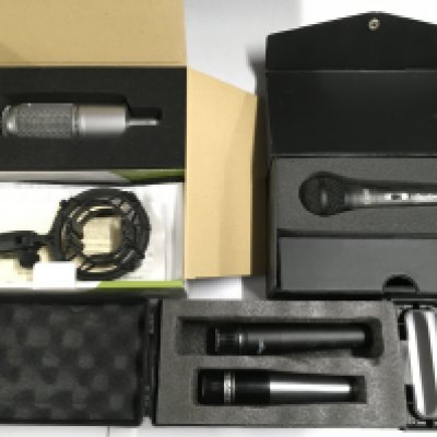 Four microphones comprising a boxed Audio Technica AT3035 example and others.