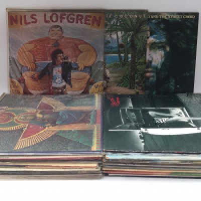 A collection of LPs snd 7" singles by various artists including Nils Lofgren, Lynyrd Skynyrd, Van Morrison and others.