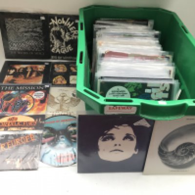 A crate of indie alternative / goth rock / punk 7" singles by various artists including The Cult, X Ray Spex, The Sisters Of Mercy, The Mission, Inspiral Carpets and others.