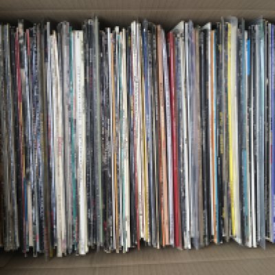 A box of LPs by various artists including OMD, The Style Council, The Clash and many more.