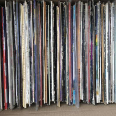 A box of LPs and 12" singles by various artists including Bruce Springsteen, Queen, The Cult and many more.