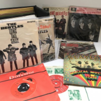 A record case of Beatles 7" singles and EPs.