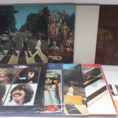 Nine Beatles LPs including 'Abbey Road', sadly scratched, 'Let It Be', 'Sgt Pepper' and others. Mostly reissues.