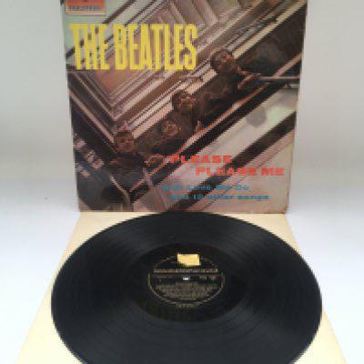 A first UK pressing of The Beatles 'Please Please Me' LP in mono with black and gold centre labels, Angus McBean credit aligned to the right of front cover and Dick James publishing credits. Some scratches, one feelable. Retail sticker stuck on Side 1 centre label. Splits to sleeve and damage to flipbacks.