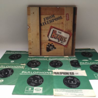 A collection of 7" singles by various artists from the 1960s onwards plus a Beatles 'From Liverpool' multi cassette box set.
