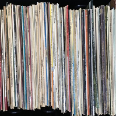 A crate of Western swing LPs by various artists including Johnny Cash, Hank Williams, Carl Perkins and others.