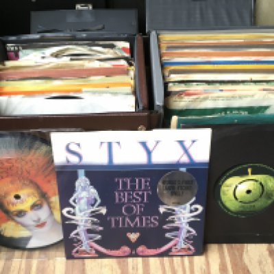 Seven record cases of 7" singles by various artists including The Beatles, The Doors, Elvis Presley and many more.