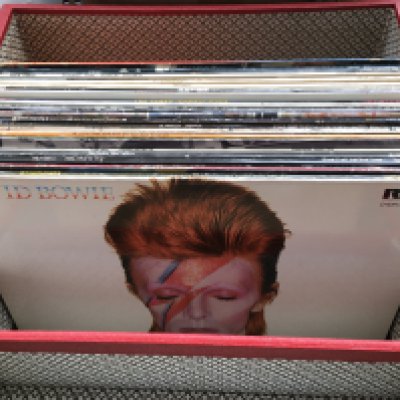 A record case of LPs by various artists including David Bowie, The Style Council, The Clash and others.