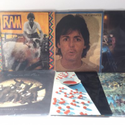 Two bags containing 12 Paul McCartney and Wings LPs comprising a 25th anniversary edition 'Band On The Run', 'Ram', 'McCartney II' and others.