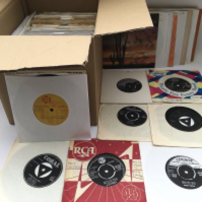 A box of rock n roll 7" singles and EPs by various artists including Elvis Presley, Billy Fury, Ricky Nelson and many more.