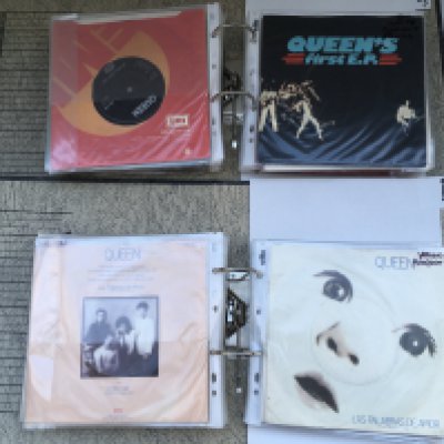 A box of four binders of Queen 7" singles including promos.