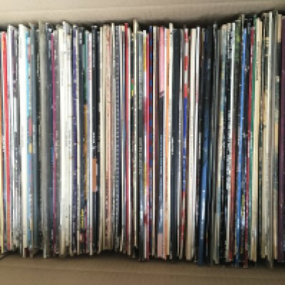 A box of LPs and 12" singles by various artists including The Beatles, Paul Weller, Queen and many more.