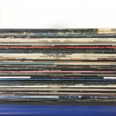 A record case of LPs by various artists including The Beatles, Eagles, Mott The Hoople and others.