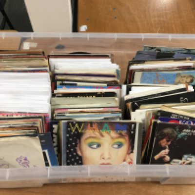 A box of 7" singles by various artists from the 1960s onwards.