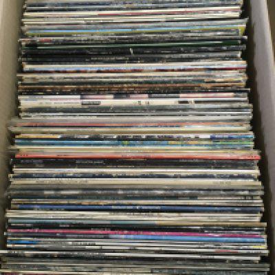 A box of LPs and 12" singles by various artists including The Beatles, Steely Dan, Soft Machine and many more,