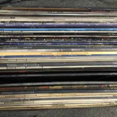 A record case and a bag of LPs and a record case of 7" singles by various artists including Black Sabbath, Thin Lizzy, Status Quo and many more,