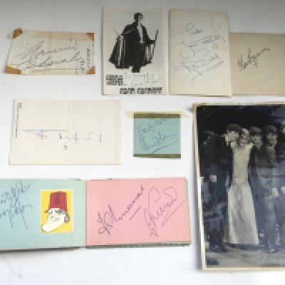 A collection of autographs both loose and in a booklet comprising James Mason, Ralph Richardson, Tommy Cooper, Kenneth Horne and others plus a press photo of The Beatles with Marlene Dietrich.