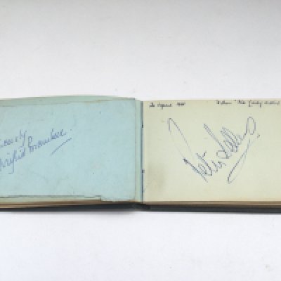 An autograph booklet containing the names of Peter Sellers, Alec Guiness, John Pertwee, Sid James, Richard Burton, Wilfred Brambell and many more.