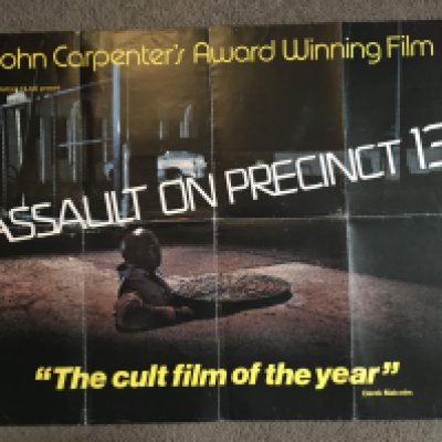 A UK quad film poster for 'Assault On Precinct 13', folded with damage to top left corner, approx 101cm x 76cm.