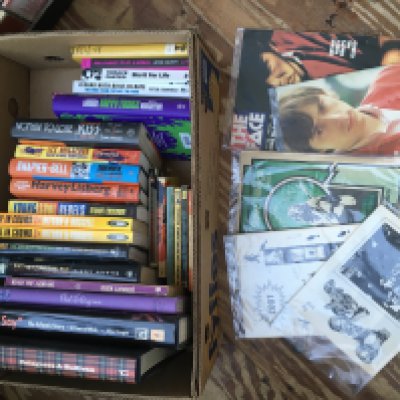 A box of music books and fanzines.